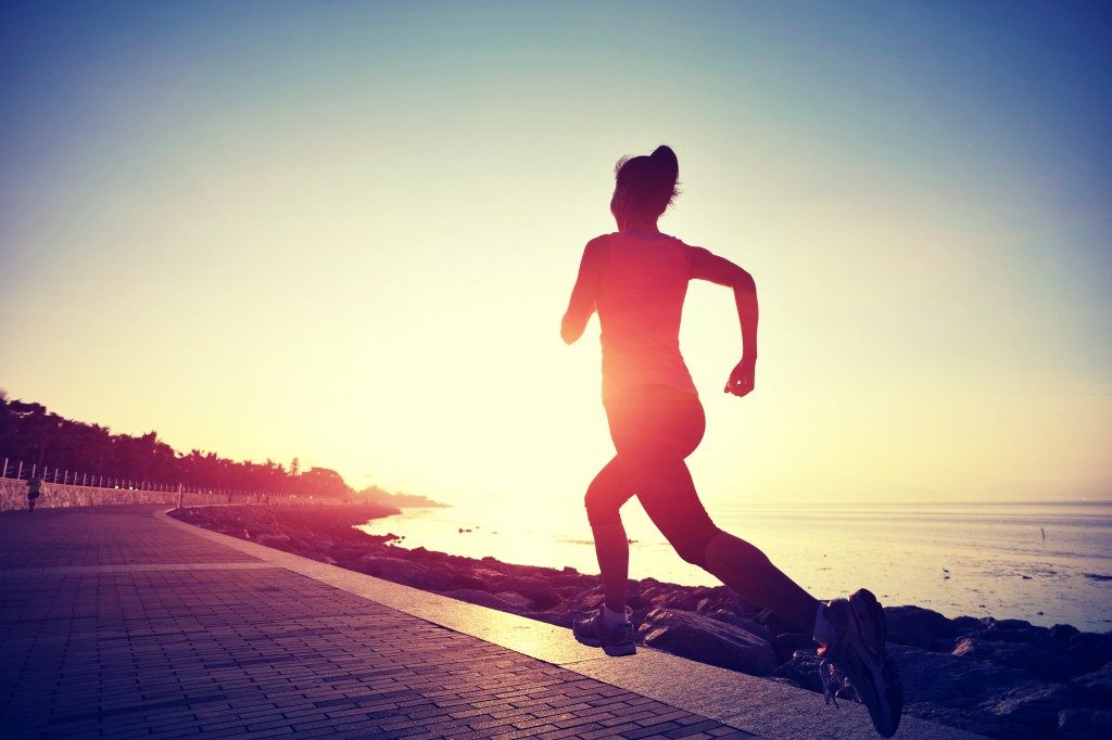 athlete running during sunrise