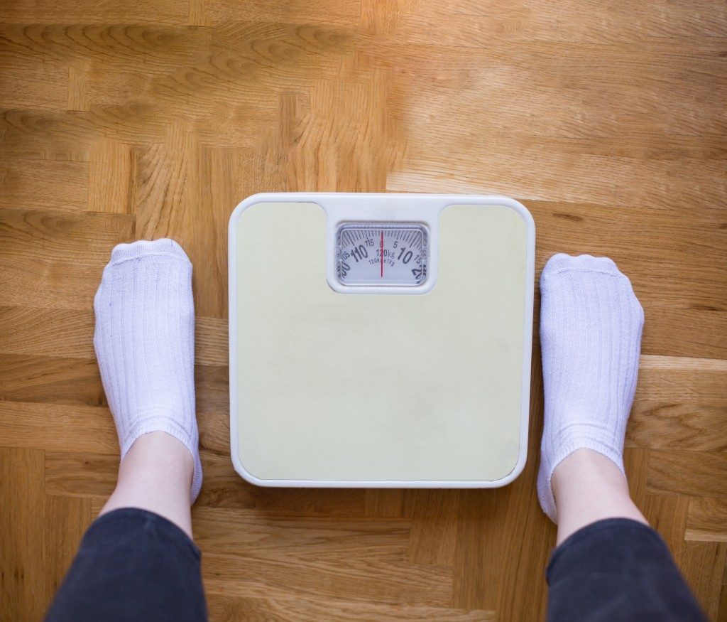 Weighing scale in front of a person