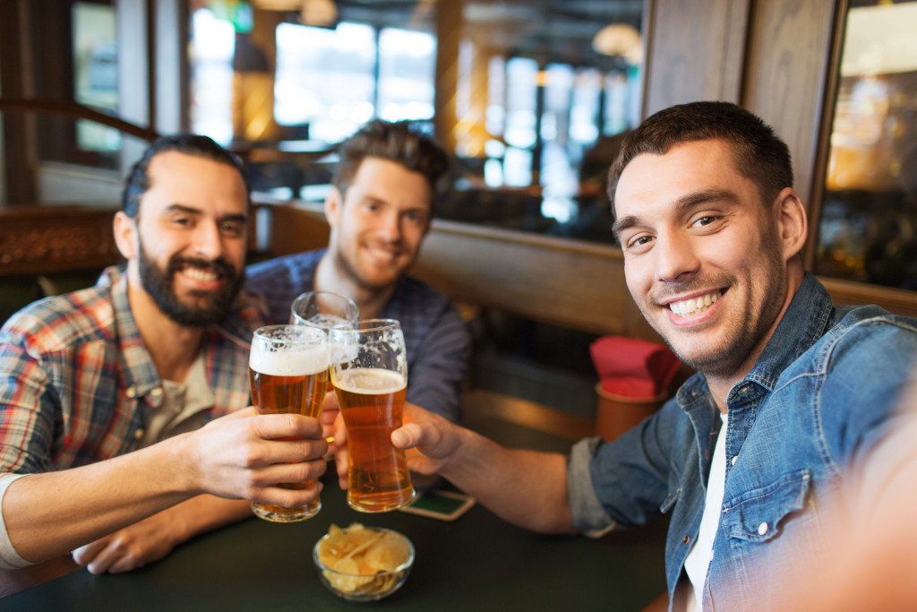 Happy men drinking beer in a bar
