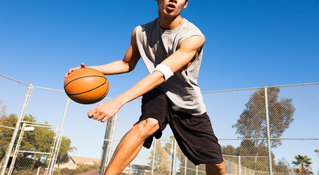 a man playing basketball outdoor